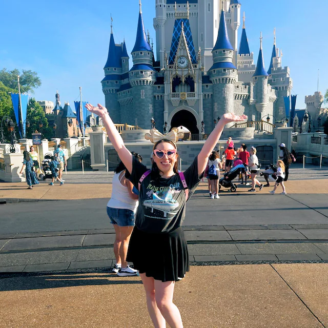 Ever After Society customer celebrating in a graphic tee during a sunny vacation day